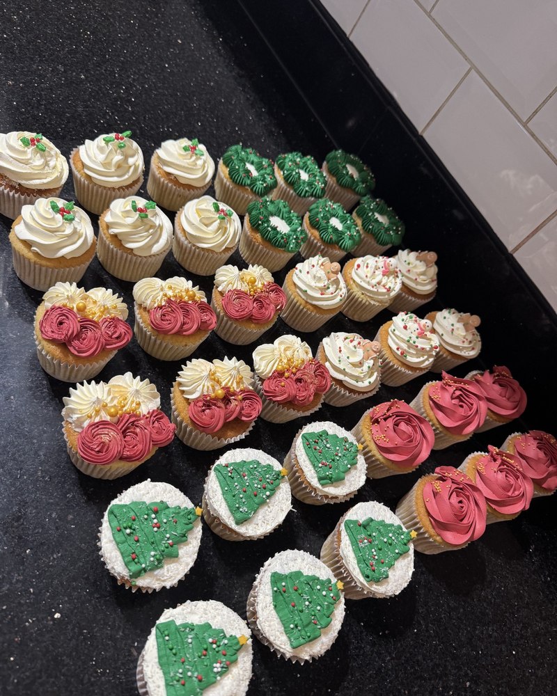 Assorted Christmas cupcakes with holly, wreath, snowflake, gingerbread and tree designs